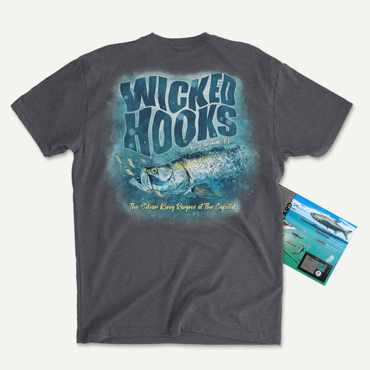 Charcoal t-shirt with a watercolor tarpon chasing baitfish: Wicked Hooks, Boca Grande, Florida, with its Catch Card