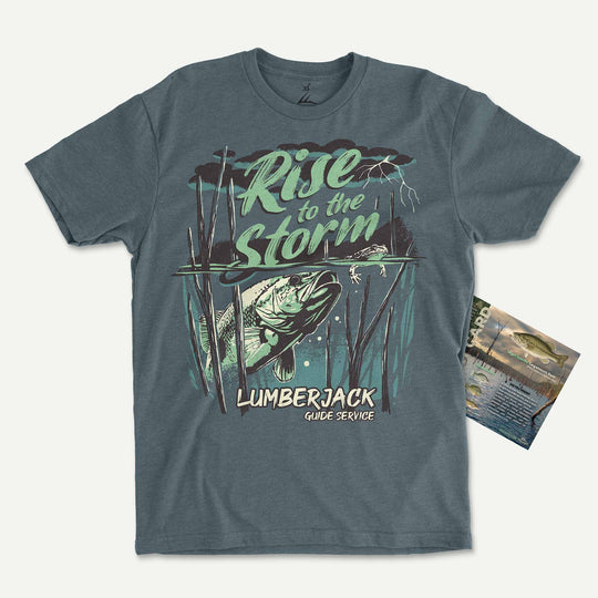 Heather Slate Blue t-shirt with a largemouth bass rising through standing timber under a storm: Rise to the Storm, with its Catch Card